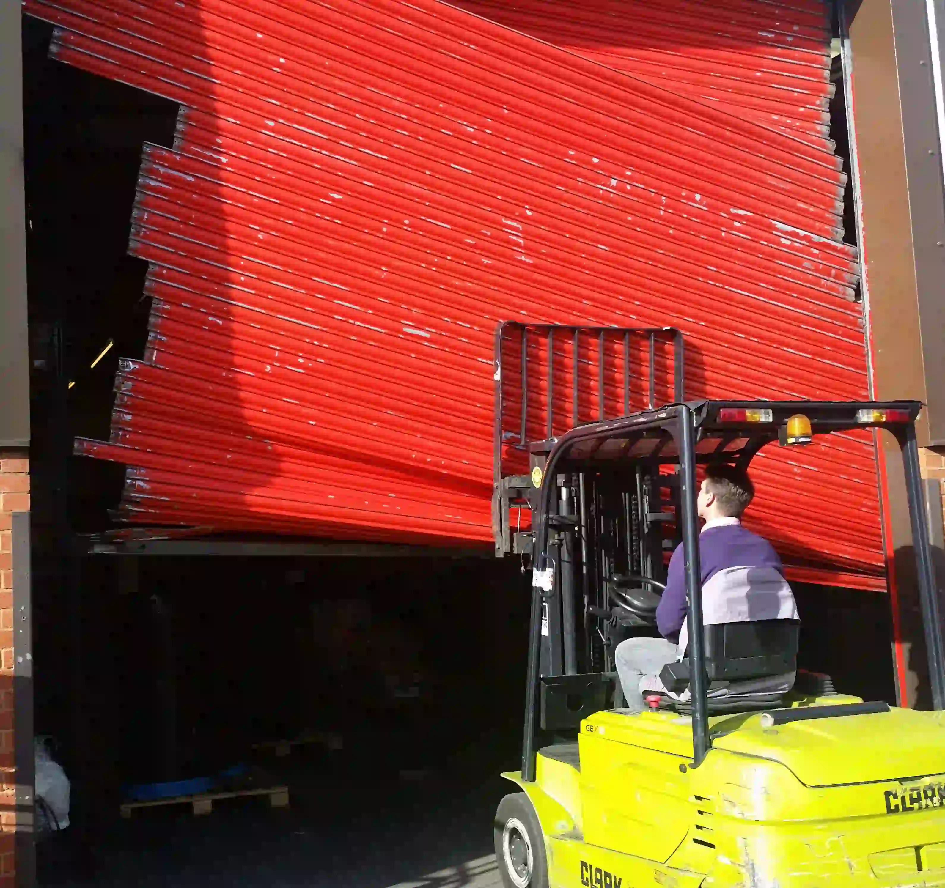 Professional engineer conducting an emergency roller shutter repair on a commercial property in London.